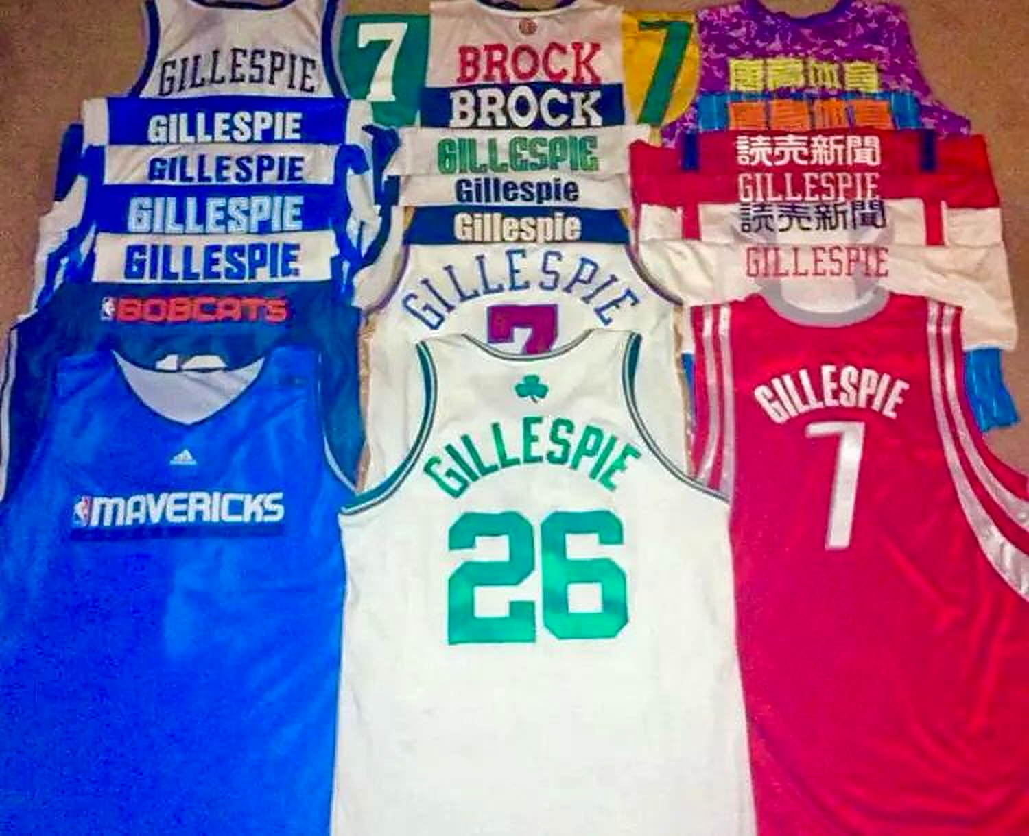 Game jerseys from Brock Gillespie's playing career, lettered in English, Chinese and Japanese